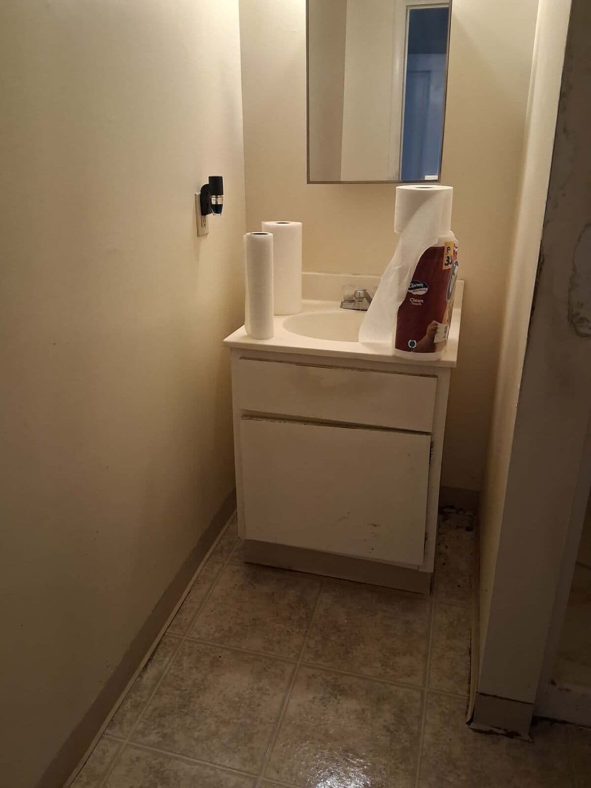 After: Bathroom cleared with clean vanity and floor