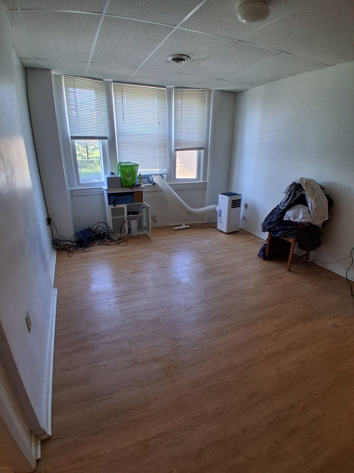 After: Same room cleared, showing the open floor and windows