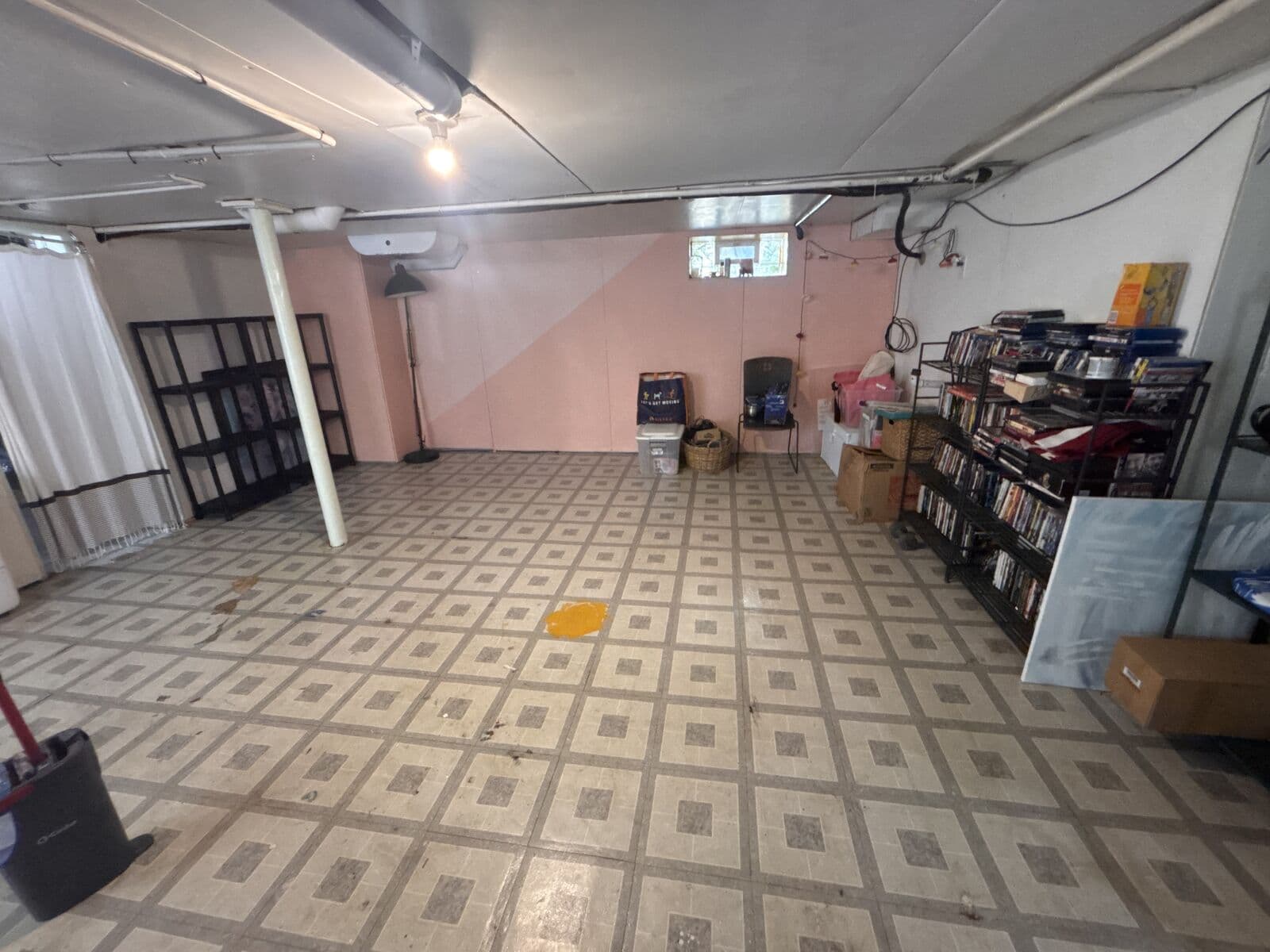 After: Same basement cleared with open tiled floor