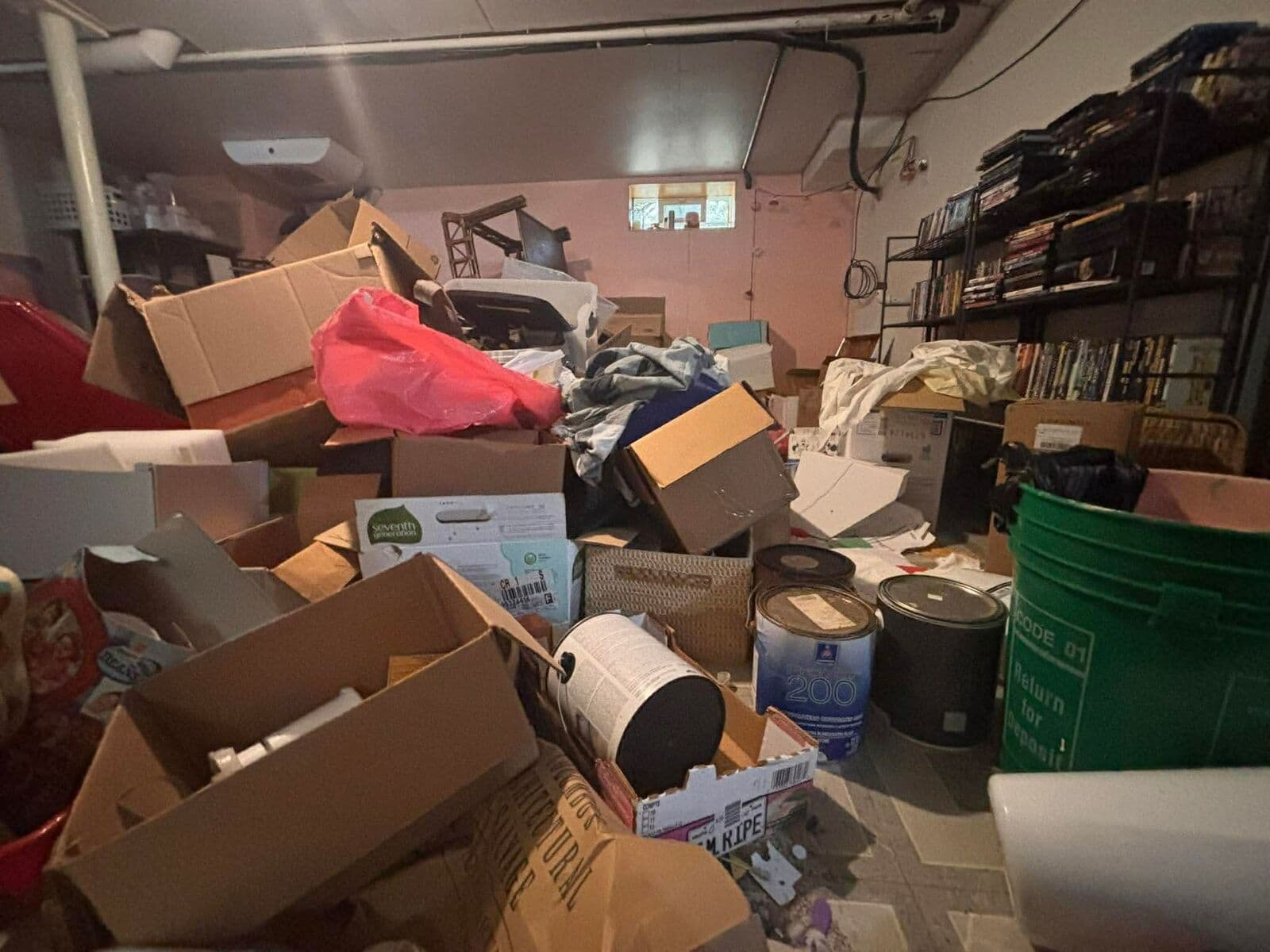 Before: Basement filled with piled boxes, bags and bins