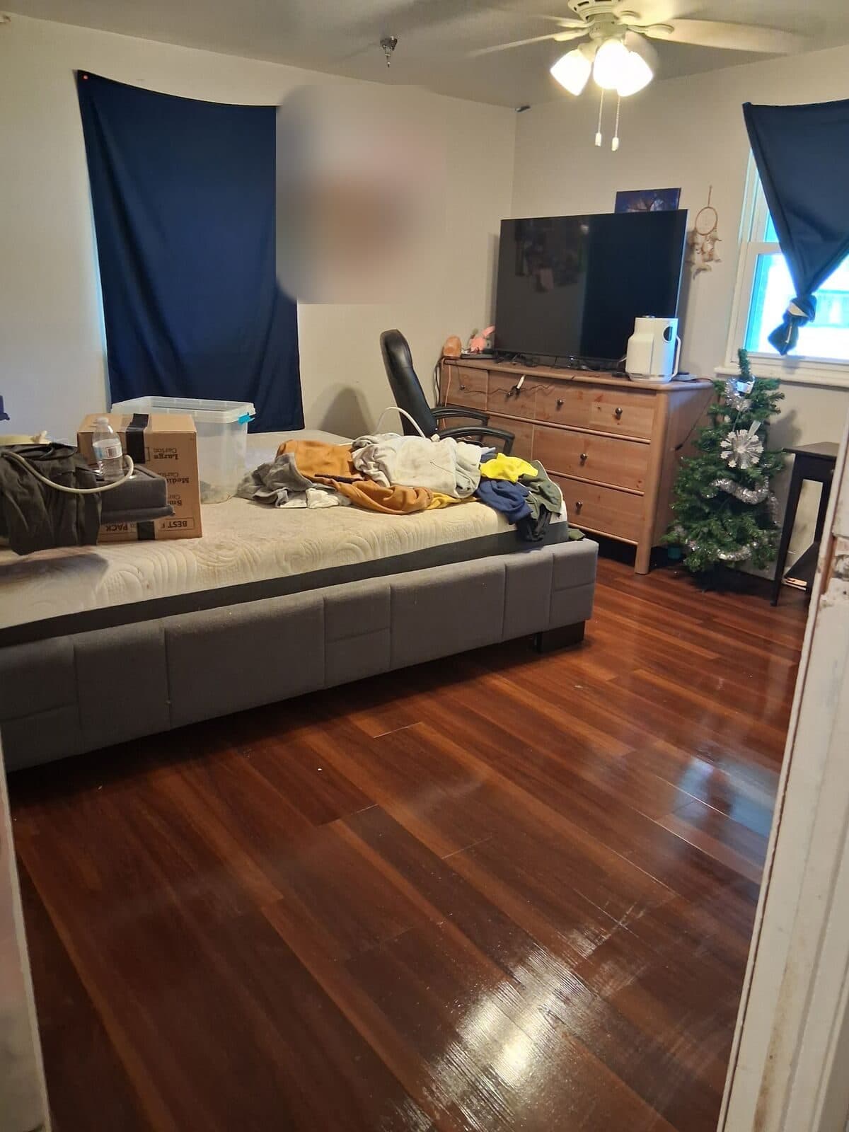 After: Bedroom cleared with clean, shining wood floor