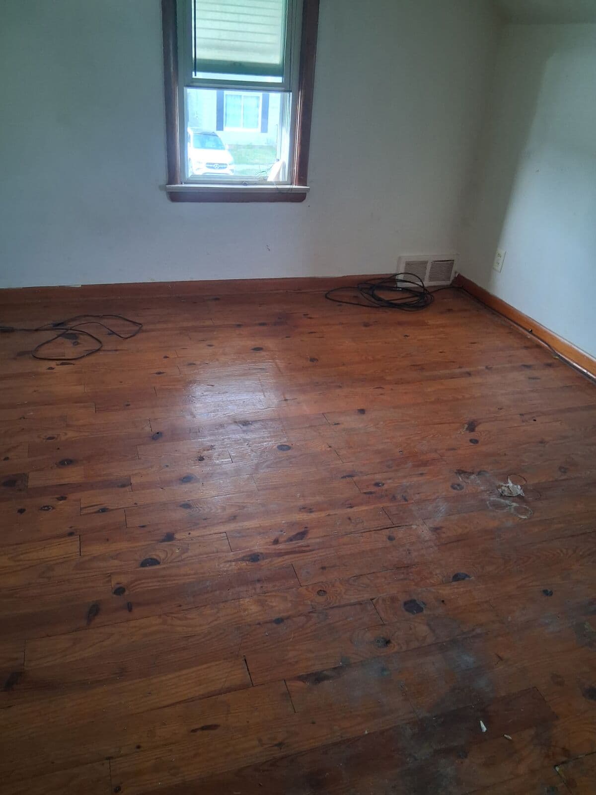 After: Upstairs bedroom cleared to the bare wood floor