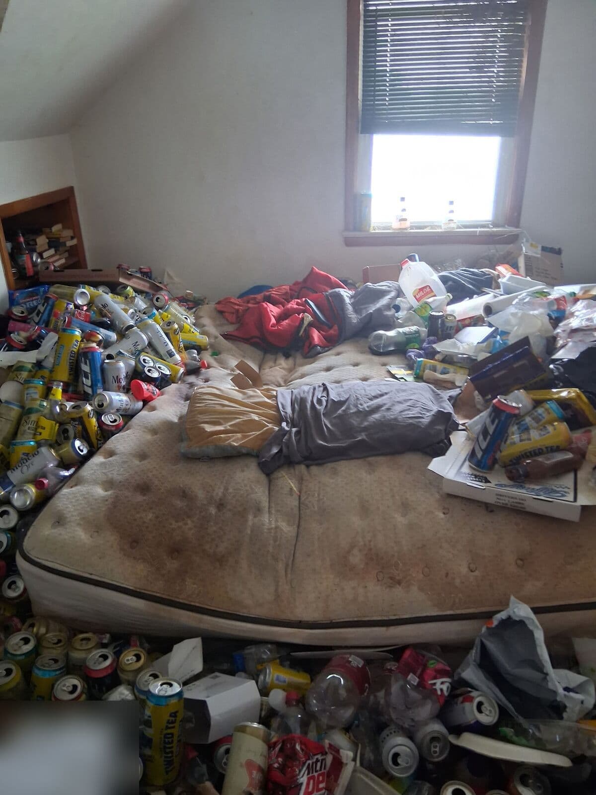 Before: Bedroom with a mattress surrounded by piles of cans and trash
