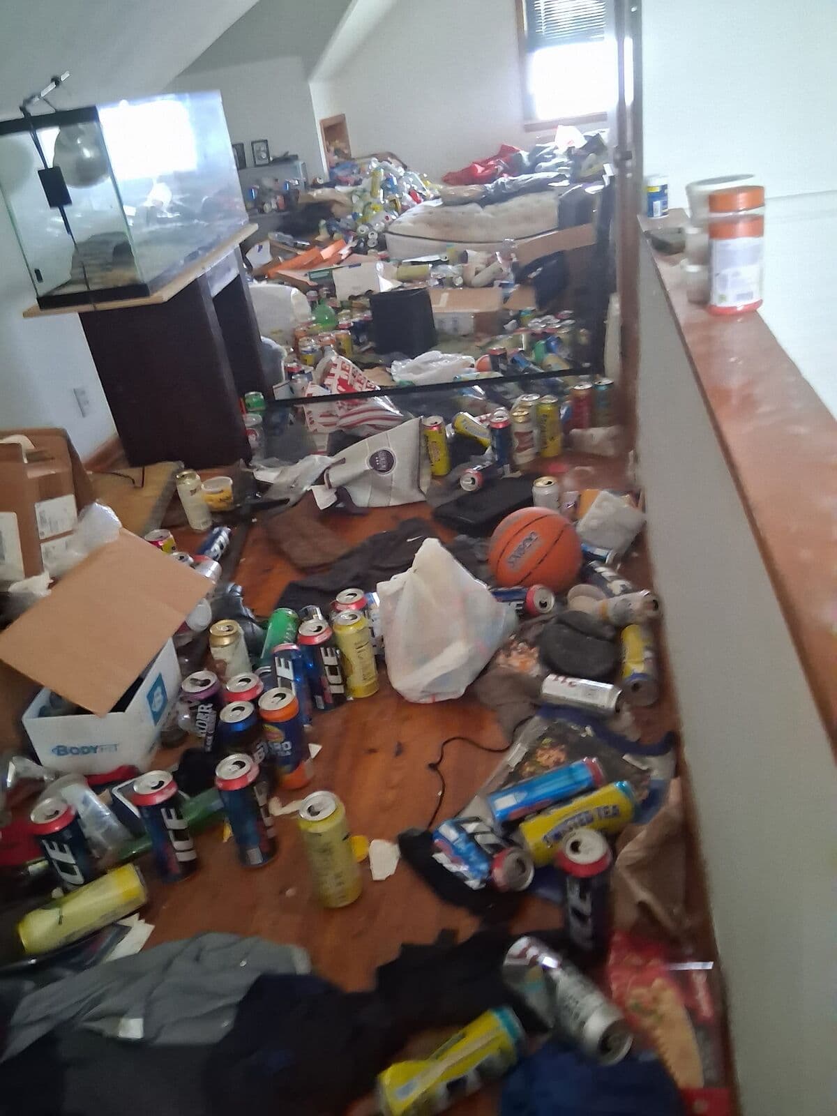 Before: Upstairs room and hallway covered in cans and debris