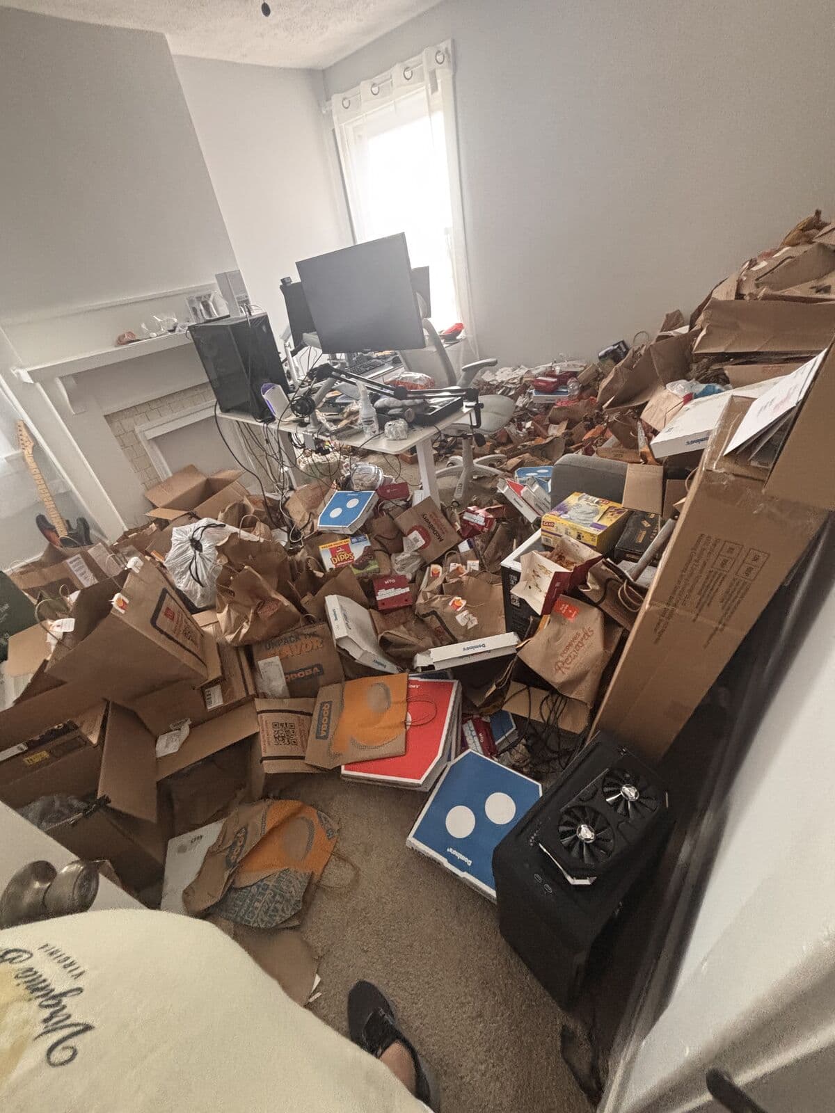 Before: Home office buried in cardboard boxes and food packaging