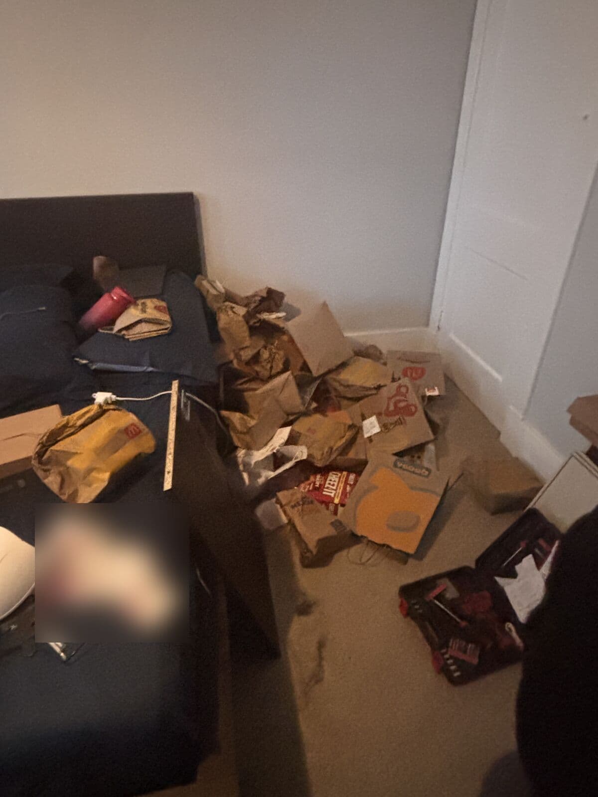 Before: Bedroom floor covered in bags and trash