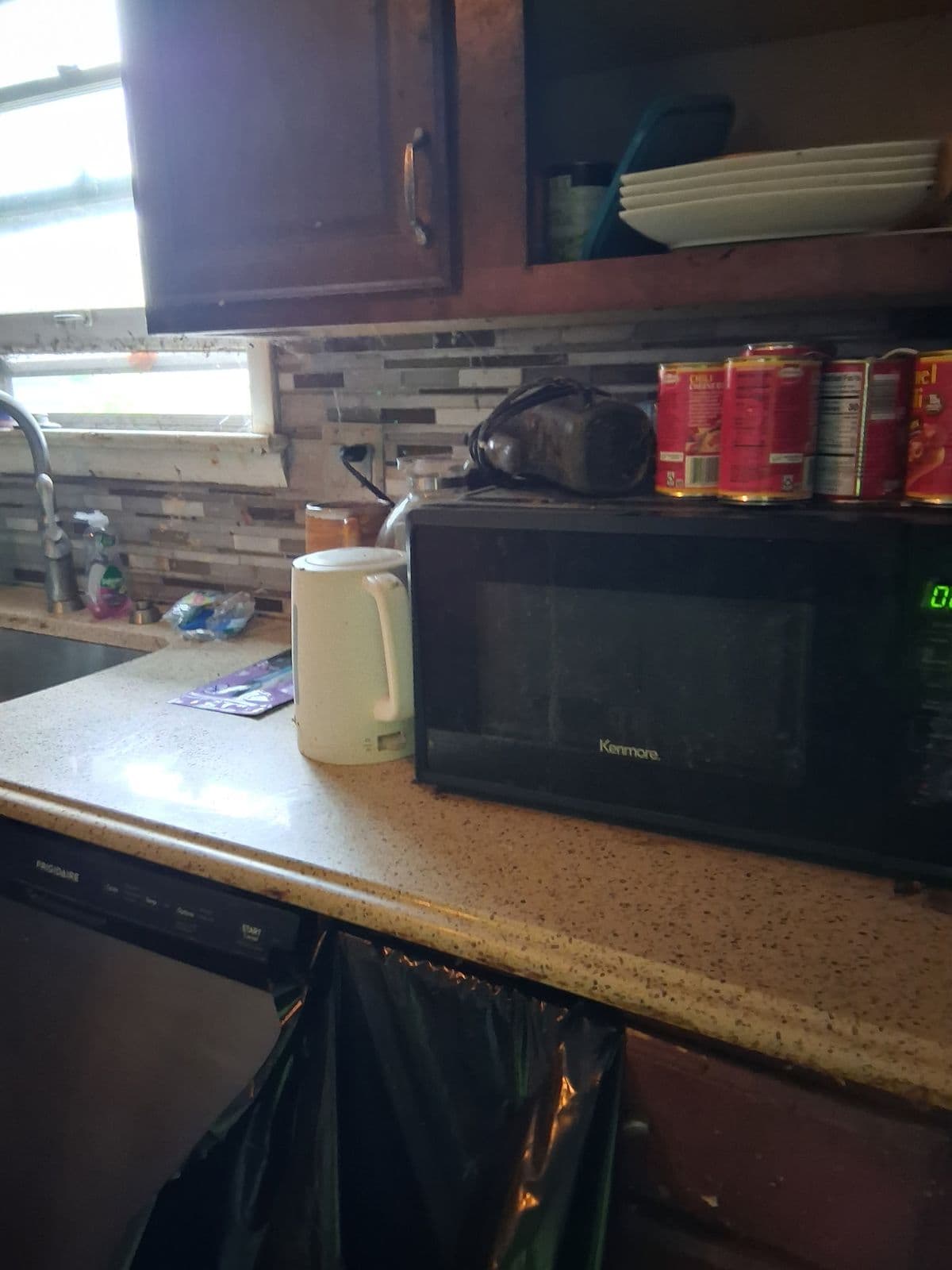 After: Same kitchen counter cleared and wiped down under the window