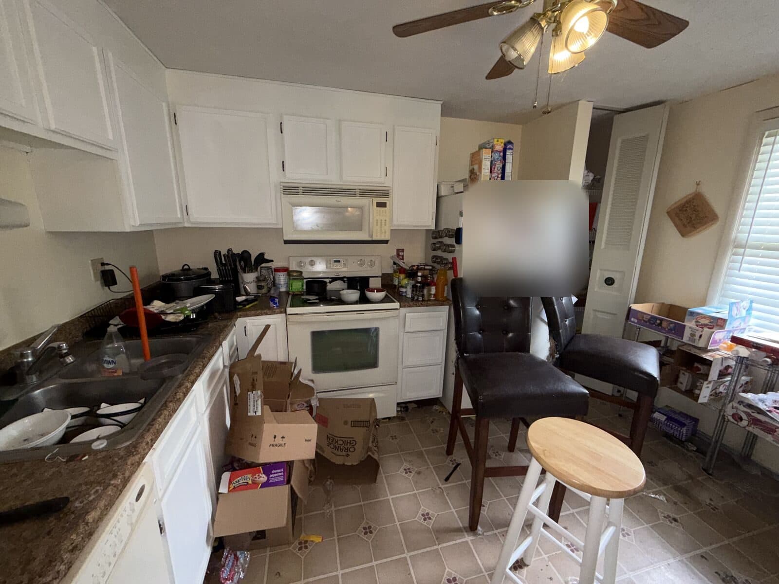 Before: Kitchen floor and counters crowded with boxes and clutter